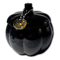 Black pumpkin-shaped container with a gold emblem on a white background