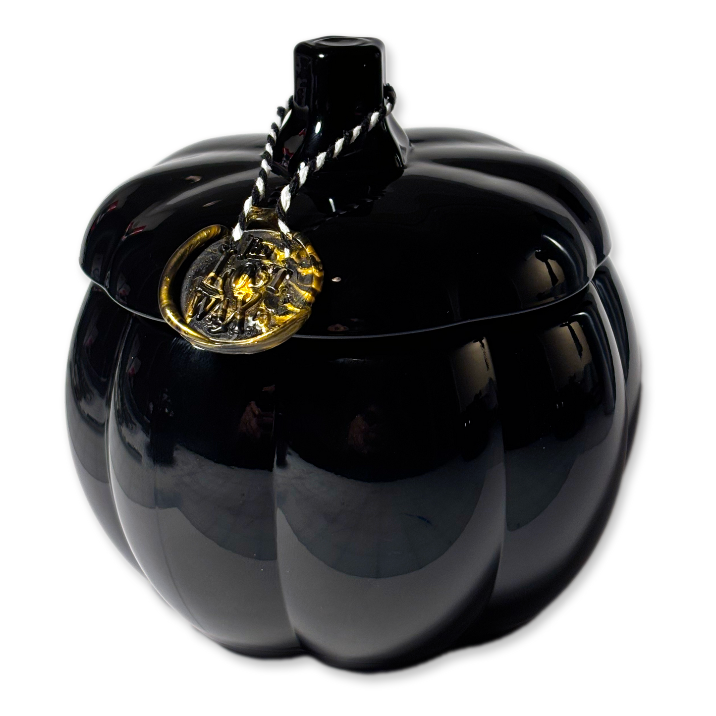 Black pumpkin-shaped container with a gold emblem on a white background