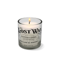 Candle in a glass container with 'The Lost Wax Company' label on a white background