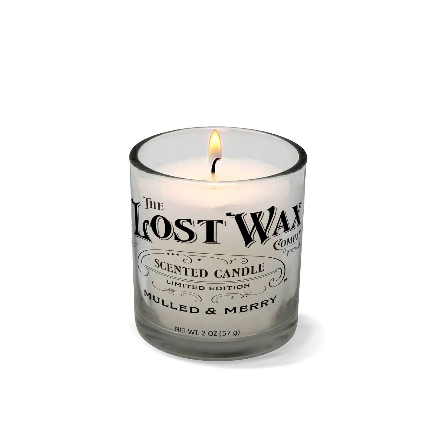 Candle in a glass container with 'The Lost Wax Company' label on a white background