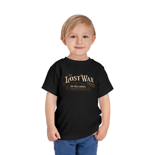 Child wearing a black t-shirt with 'The Lost Wax' logo on a white background
