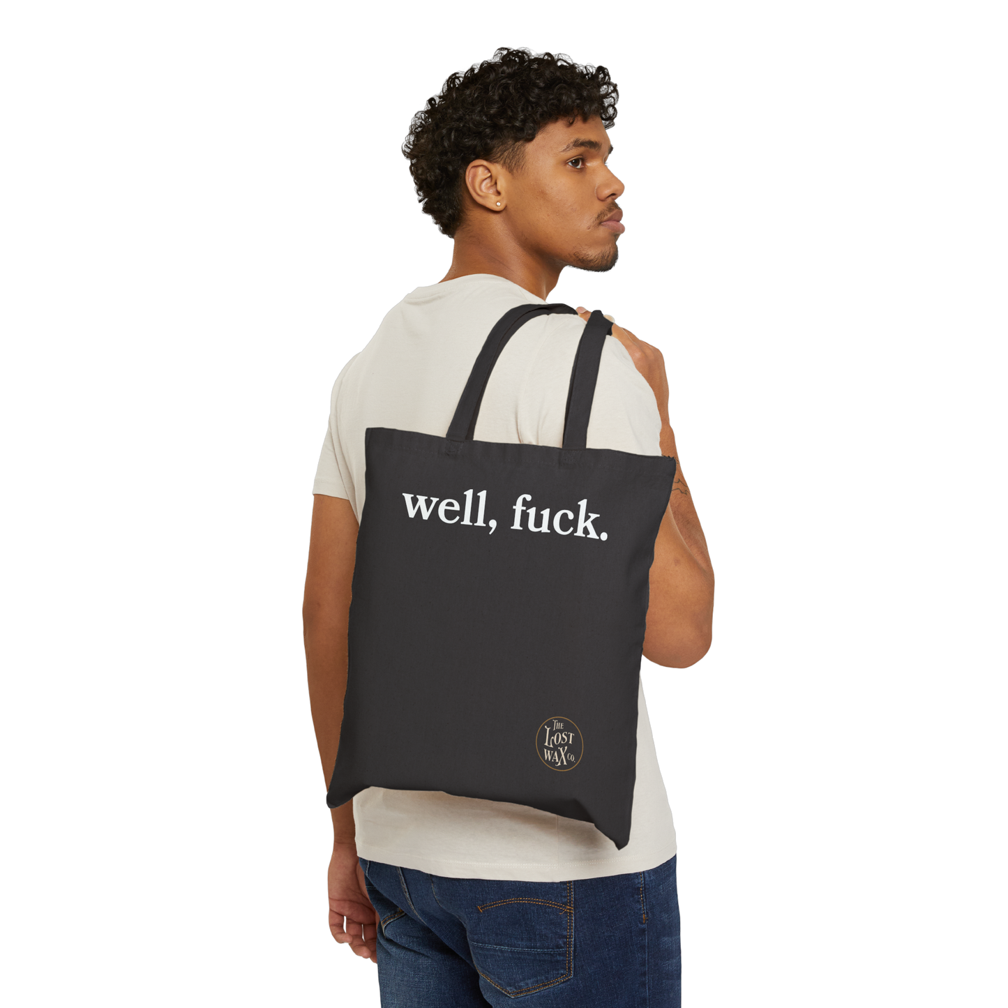 Man carrying a black tote bag with 'well, fuck.' text on a white background