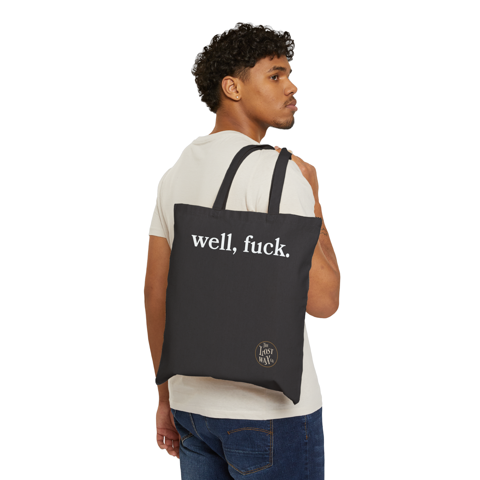 Man carrying a black tote bag with 'well, fuck.' text on a white background