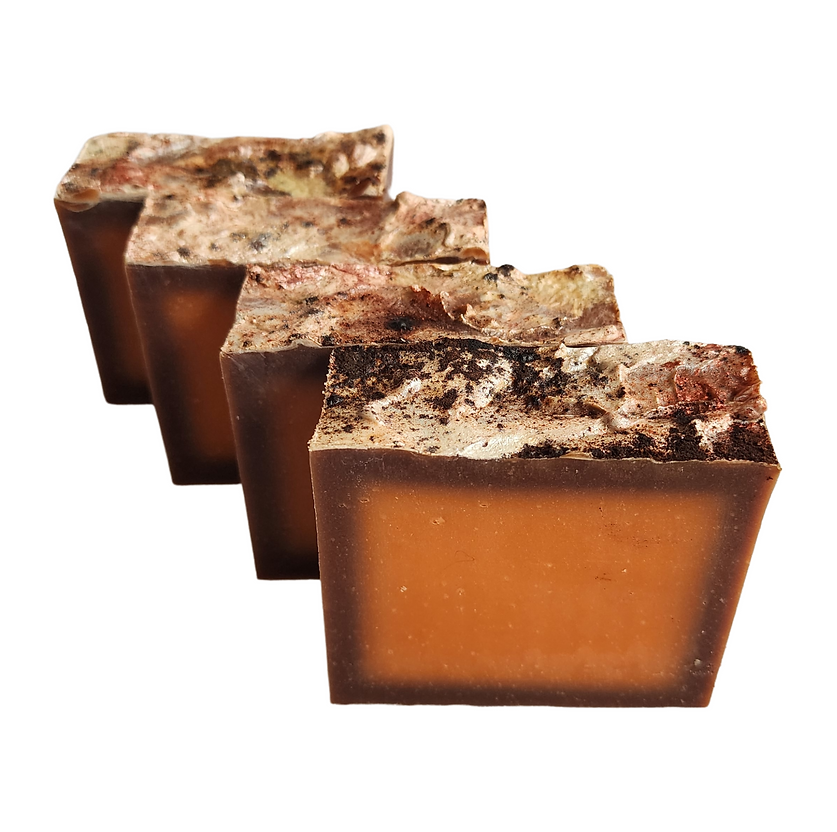 Four handmade soaps with a rich coppery chocolate color, and textured tops.