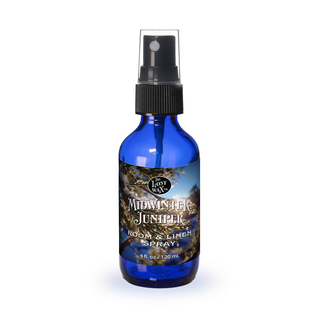 Blue spray bottle labeled 'Midwinter Juniper' on a white background