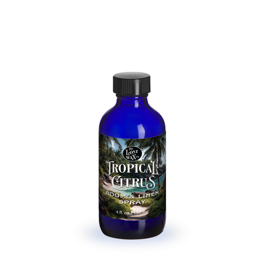 Blue bottle with a label featuring a tropical scene on a white background