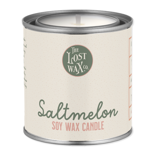 Scented candle in a tin with 'The Lost Wax Co.' branding on a white background