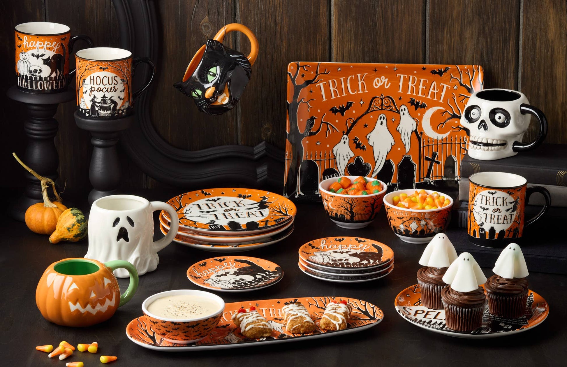 Halloween-themed tableware set with mugs, plates, and bowls featuring ghost and pumpkin designs.
