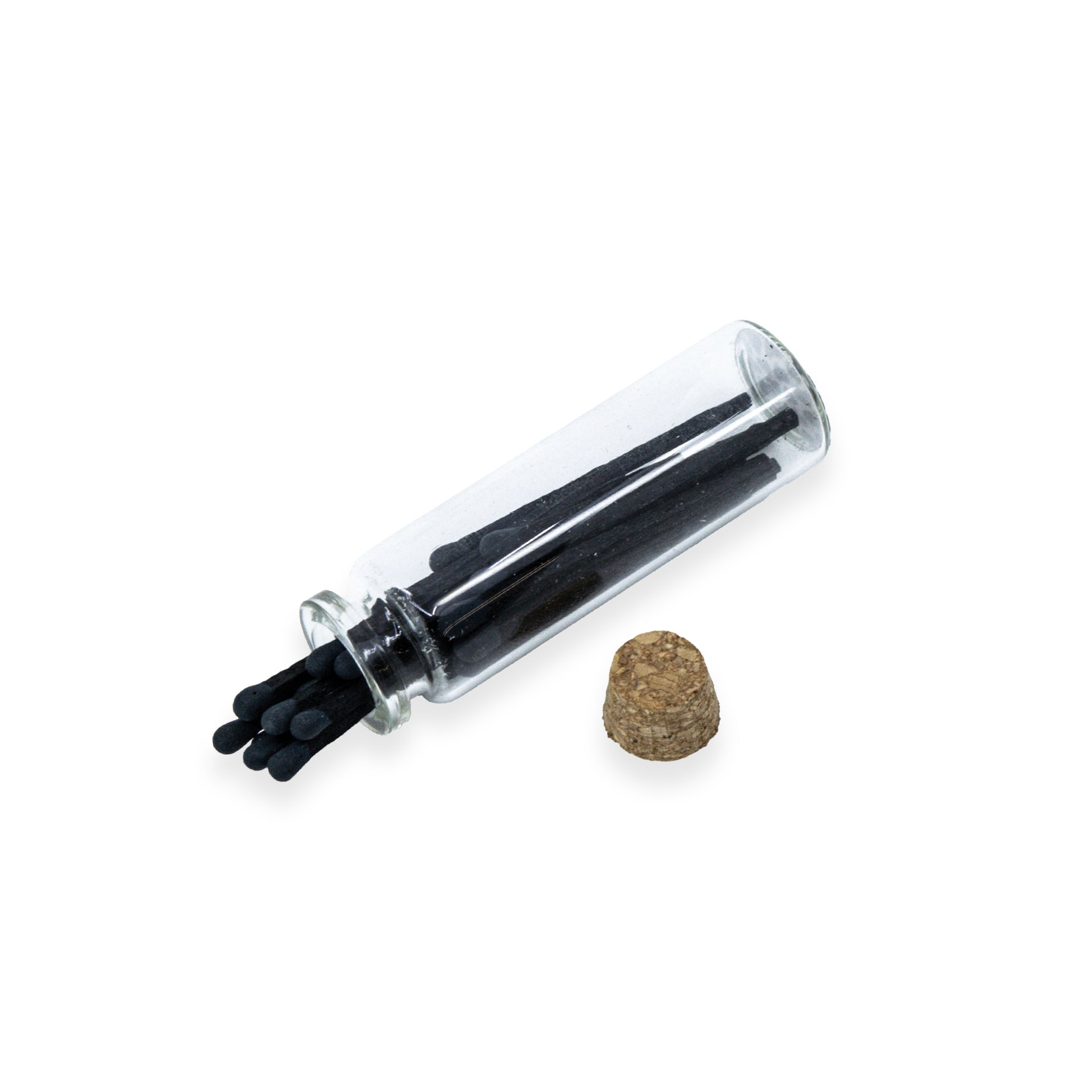 Small clear glass bottle with black matches inside and cork.