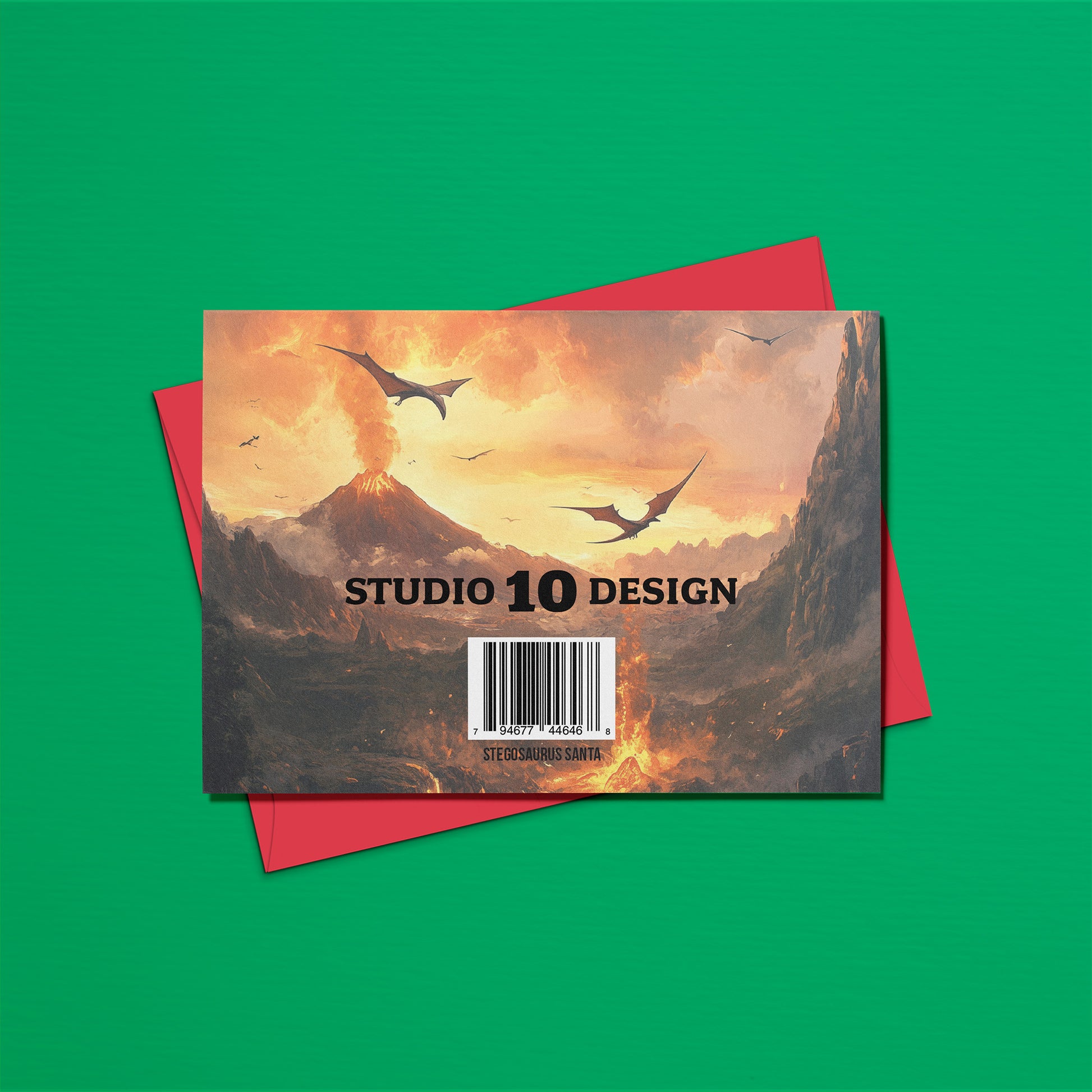 Card with a mountain and dragon design on a red envelope against a green background, featuring 'Studio 10 Design'.