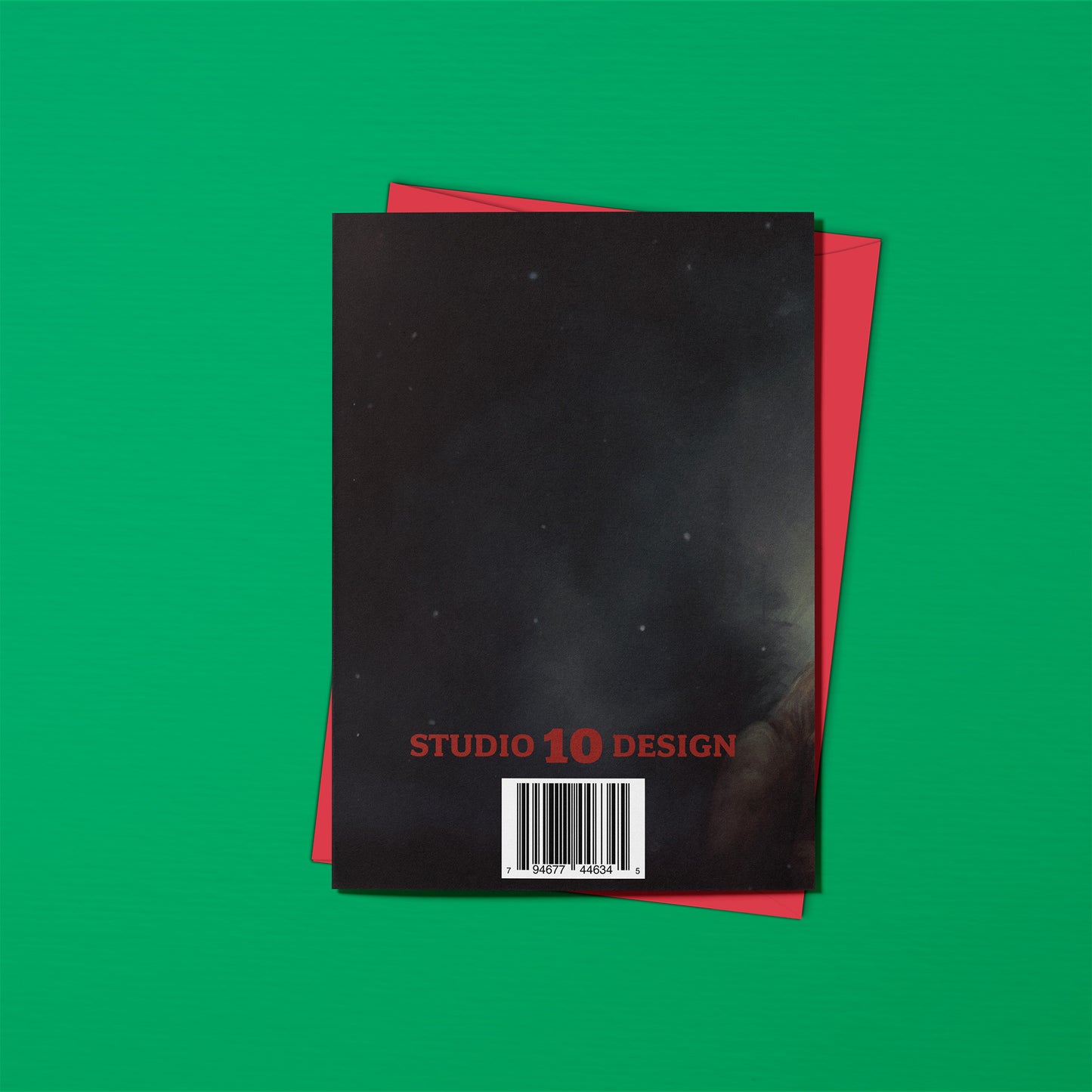 Black and red notebook with 'Studio 10 Design' branding on a green background