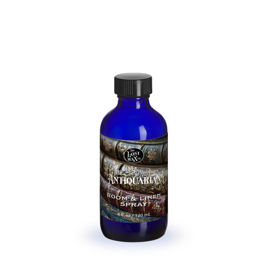 Blue bottle of room and linen spray with a label on a white background