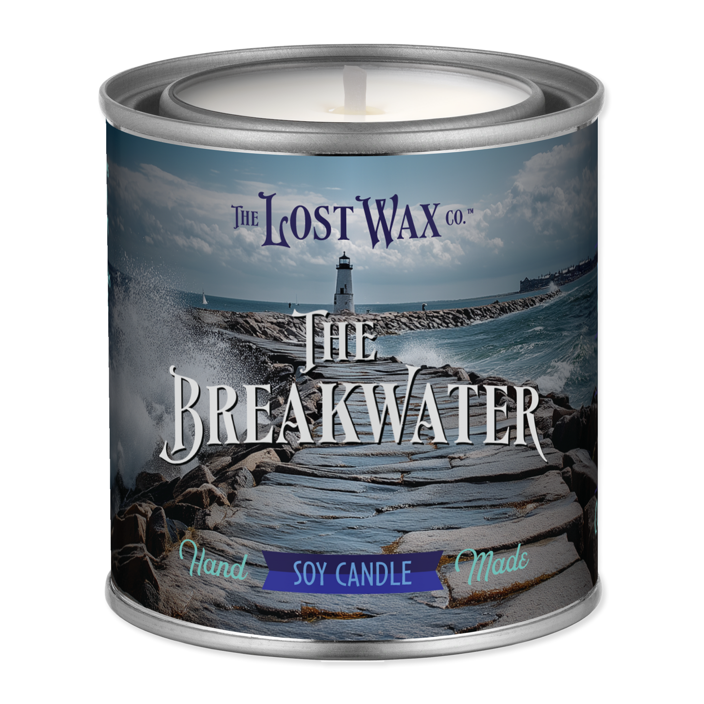 Candle in a tin labeled 'The Breakwater' from The Lost Wax Co. with a scenic design on the label.