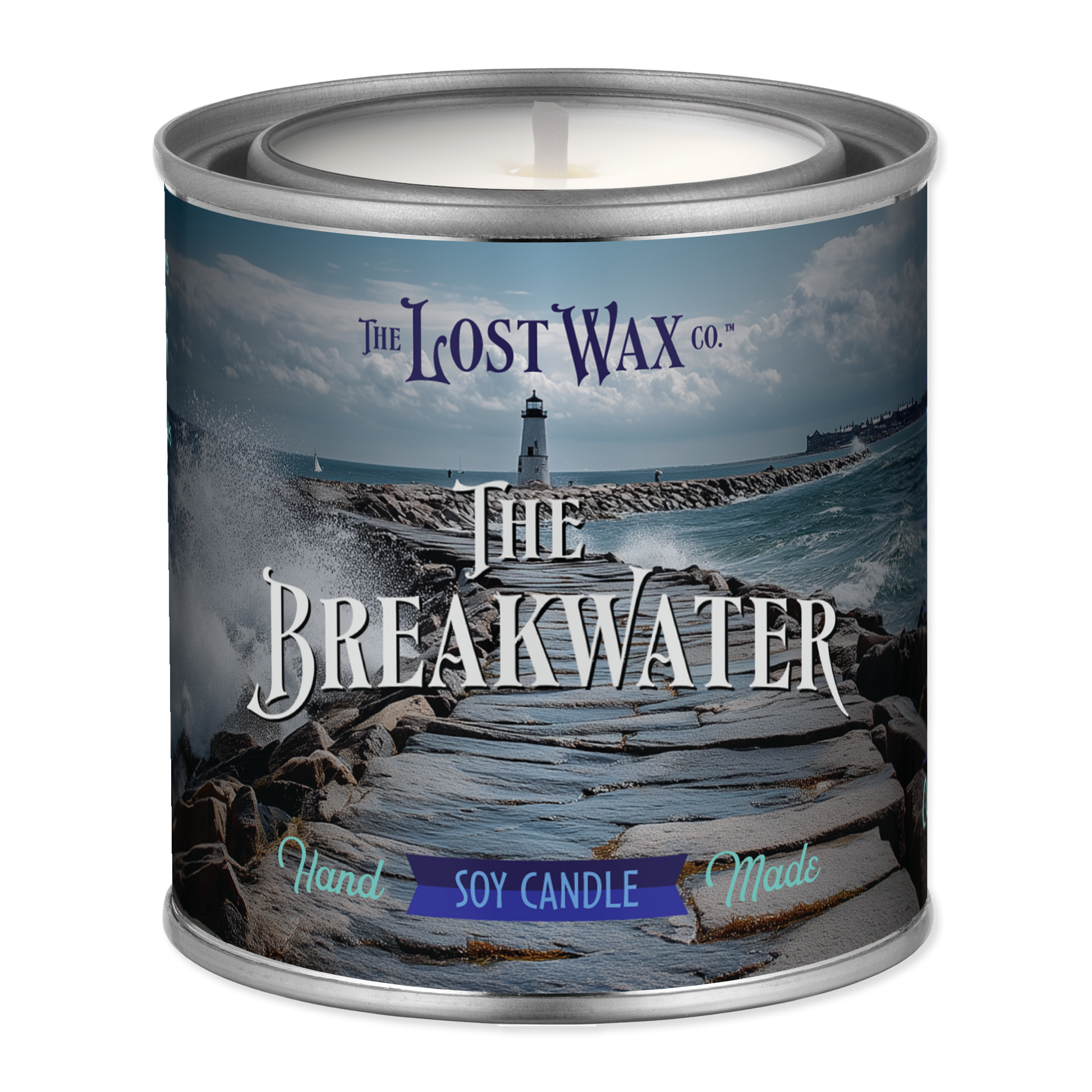 Candle in a tin labeled 'The Breakwater' from The Lost Wax Co. with a scenic design on the label.