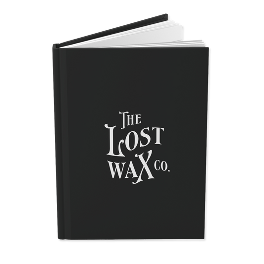 Black book with 'The Lost Wax Co.' logo on a white background