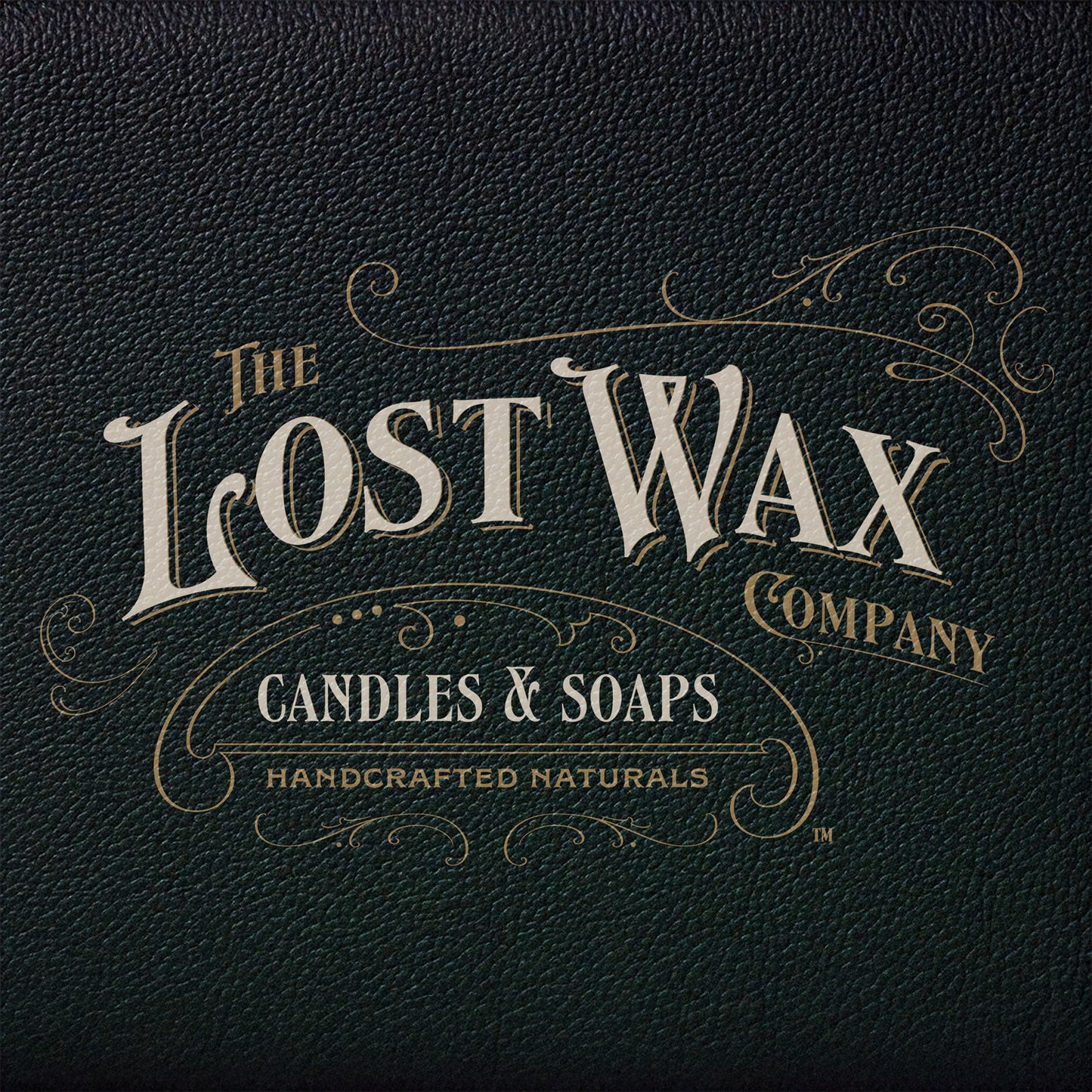 Logo of The Lost Wax Company on a dark leather textured background