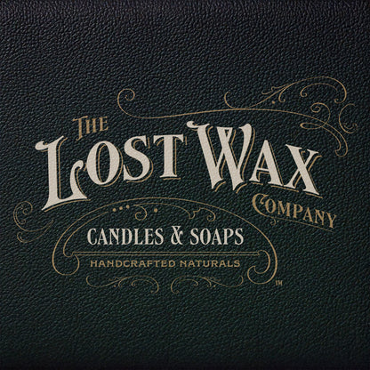 Logo of The Lost Wax Company on a dark leather textured background
