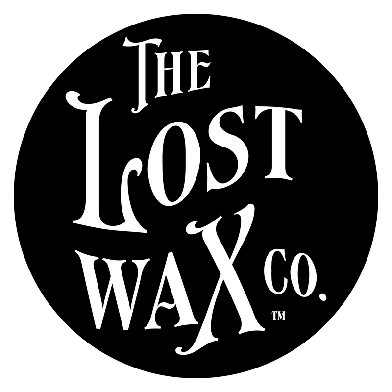 Logo of The Lost Wax Co. with white text on a black background