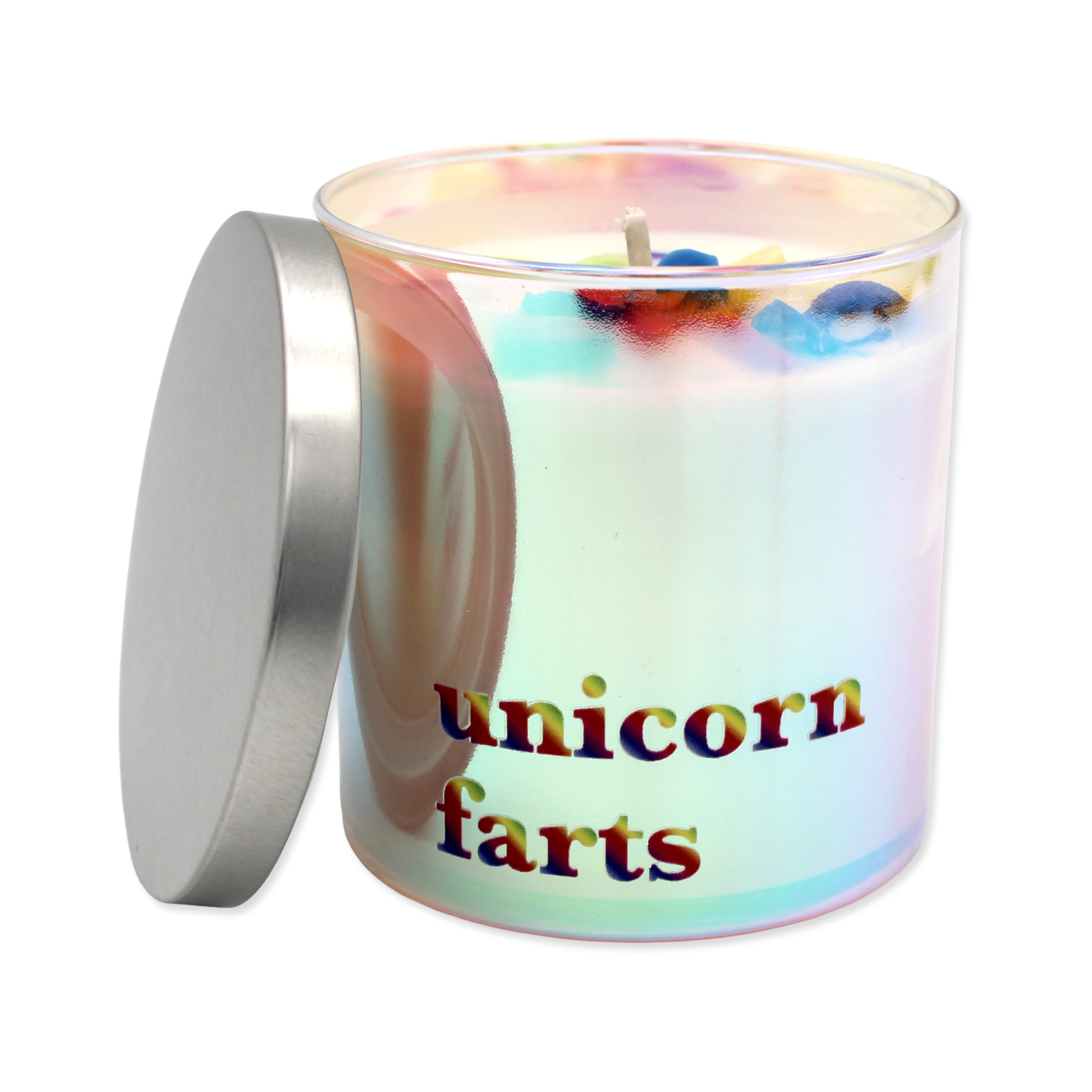 Colorful candle with fruit-shaped wax pieces in a glass container on a white background