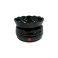 Black ceramic bowl with a red dot on a white background