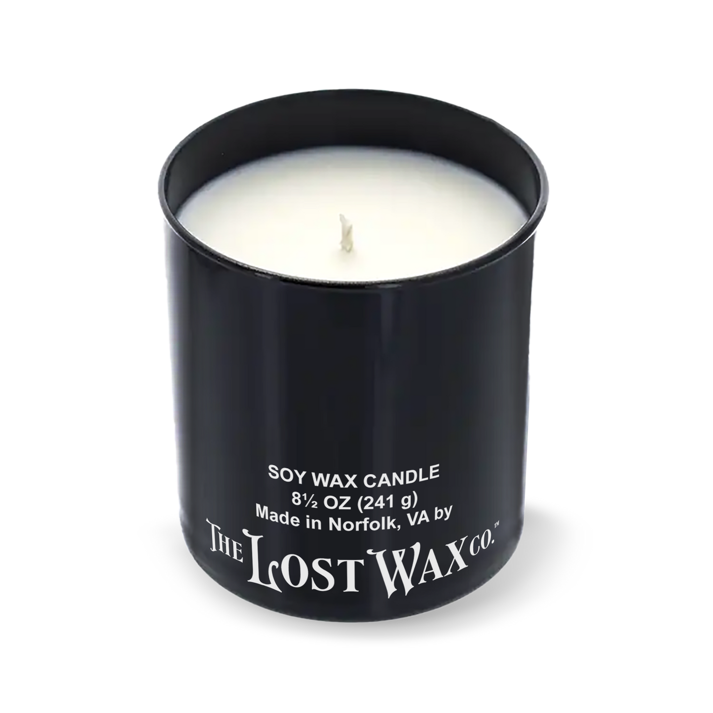 Black candle container with white candle inside, featuring 'The Lost Wax Co.' branding on a white background.