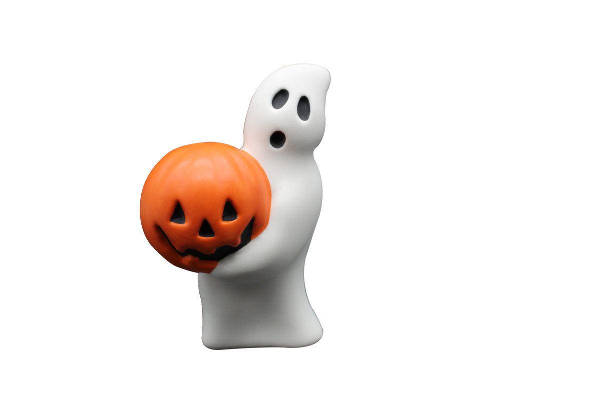 A white ghost-shaped Halloween decoration holding a carved orange jack-o'-lantern pumpkin, isolated on a solid black background.