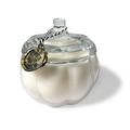 White ceramic pumpkin-shaped container with a clear glass lid on a white background
